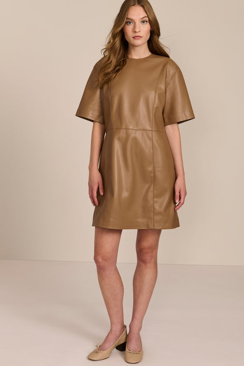 women's camel faux leather shift dress featuring short sleeves, a crew neckline, seam detailing and side pockets.