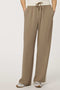 Woman wearing a pull-on wide leg trouser with side stripe in taupe, featuring elastic drawstring waistband and relaxed fit.