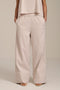 Woman wearing striped wide leg pants with elastic waistband and relaxed silhouette.