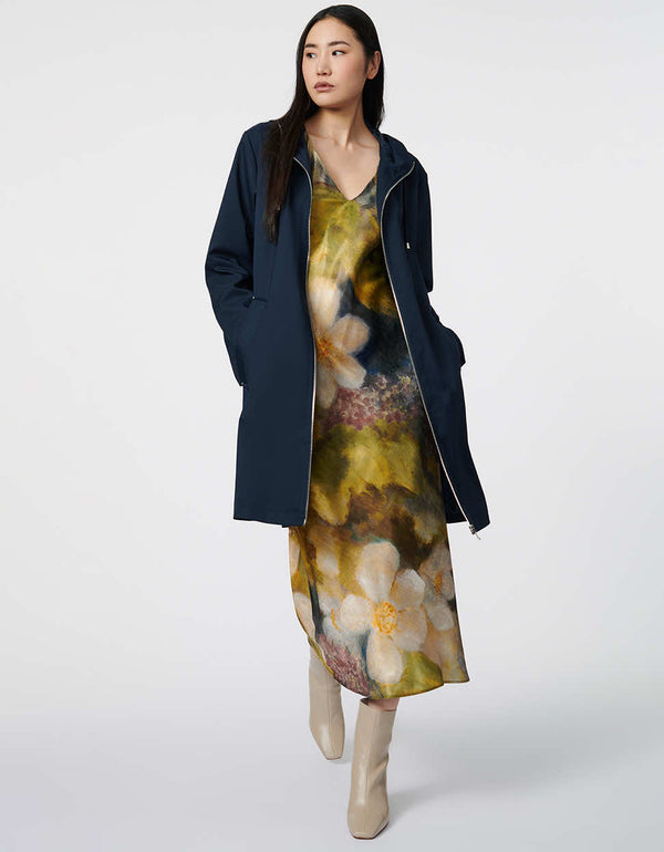 keep dry in this oversized navy blue raincoat made with recycled materials