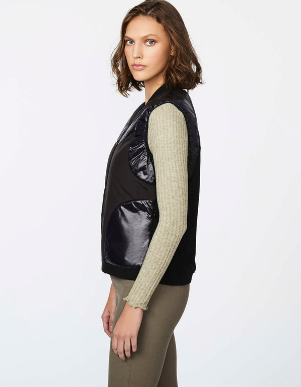 lightweight black puffer vest for women featuring glossy bands and sustainable ecoplume filler