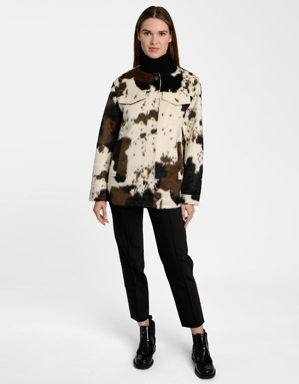A cowprint women's utility jacket on a model.