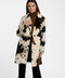 A woman wearing the Dakota Cow Print Tailored Coat for women.