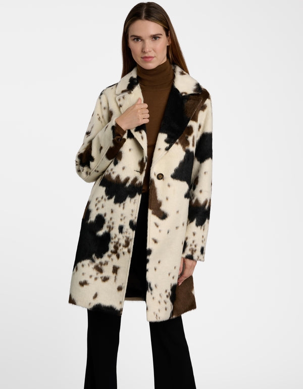 A woman wearing the Dakota Cow Print Tailored Coat for women.