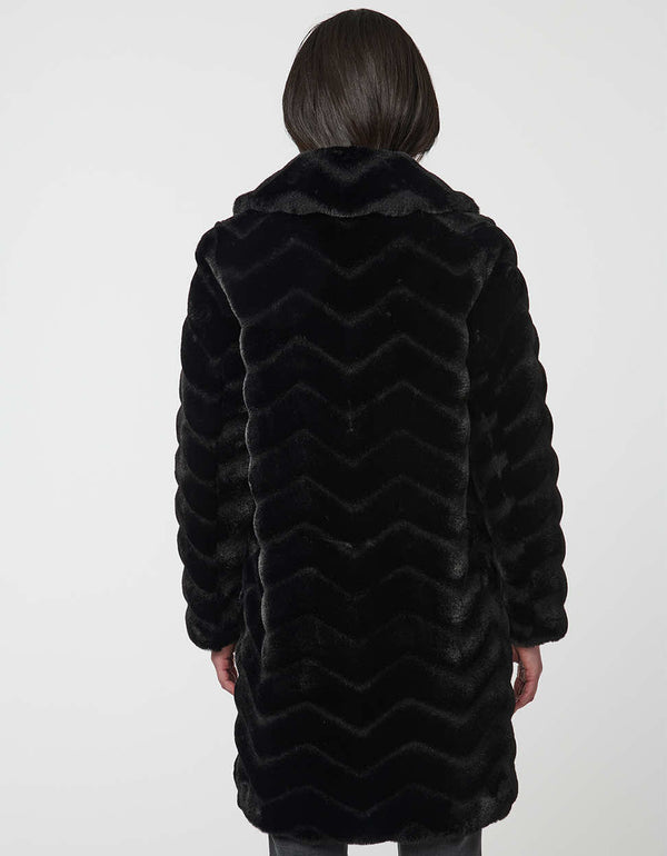 oversized vegan fur coat with tonal zigzag seams and angled hand pockets mid length design