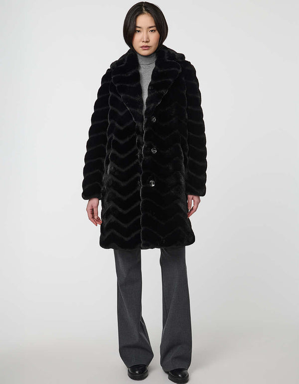 oversized vegan fur coat with tonal zigzag seams and angled hand pockets mid length design