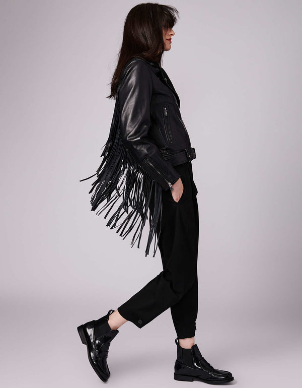 black genuine leather outerwear with extra long fringe with a semi fitted fit and falls down on hip length