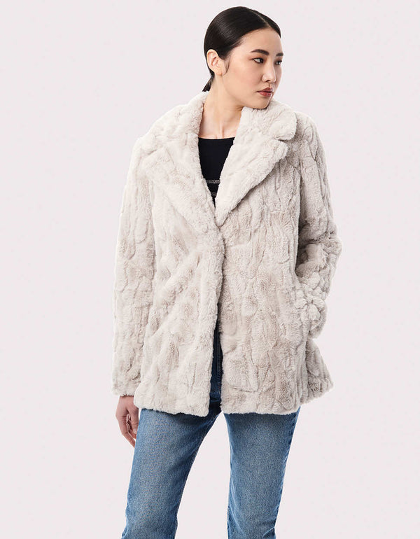 white faux fur outerwear for women in classic mid length fit with tonal texture and hint of pattern