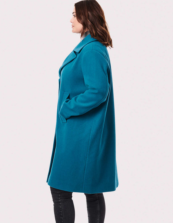 oversized mid length wool coat for women with traditional lapel button closure and ample hand pockets to keep them warm