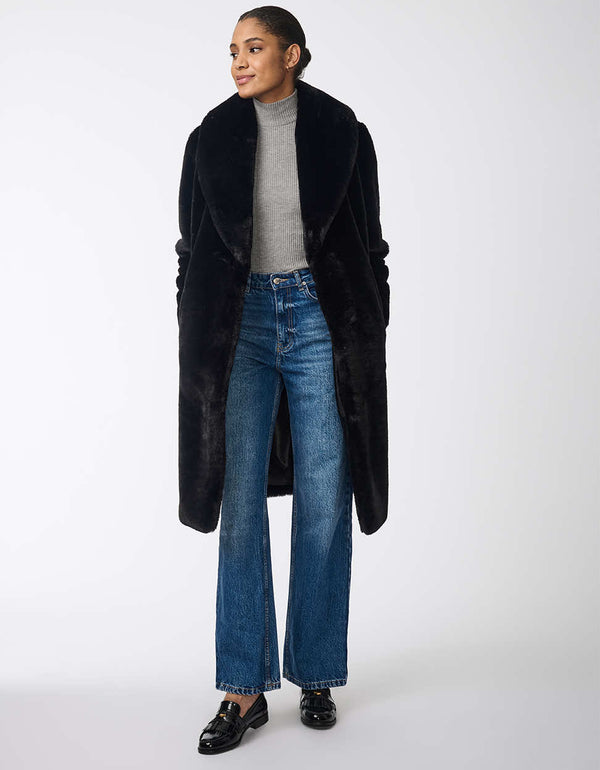 womens black faux fur coat featuring a wide lapel collar deep side pockets and a classic fit for a chic winter look