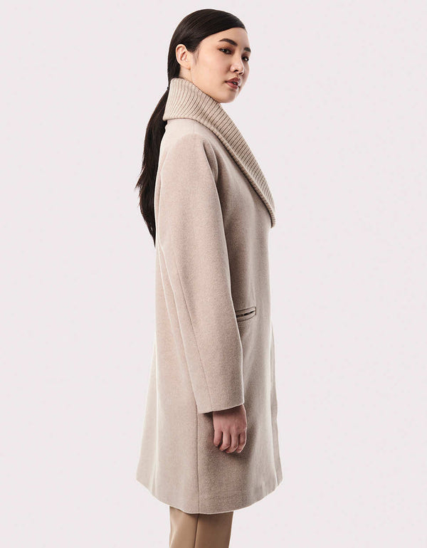 beige wool blend outerwear with an oversized mid length fit and hidden buttons to keep the relaxed fit