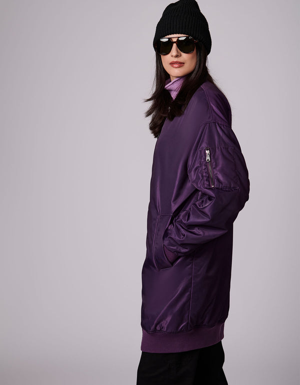 side shot of an iconic dark violet bomber street style jacket that will make your outfit hip and cool in a few seconds