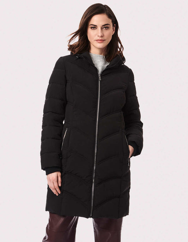 A quilted puffer coat in a walker mid-length keeps heat in with eco-friendly insulation made from recycled plastic bottles, hood and storm cuffs.