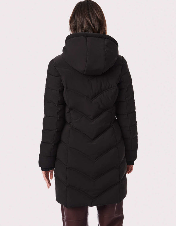 A quilted puffer coat in a walker mid-length keeps heat in with eco-friendly insulation made from recycled plastic bottles, hood and storm cuffs.