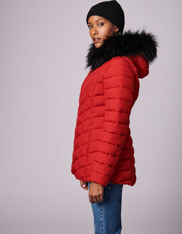 This women's puffer jacket has versatile, sustainable style with detachable vegan fur trim on the hood. Made from recycled materials.