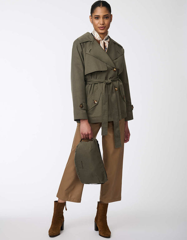 olive green trench coat for women with an adjustable belt paired with a matching travel pouch