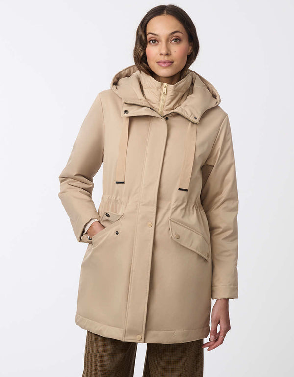 zip up and water resistant light beige hooded jacket for women with removable insulated bib for rainy and cold days