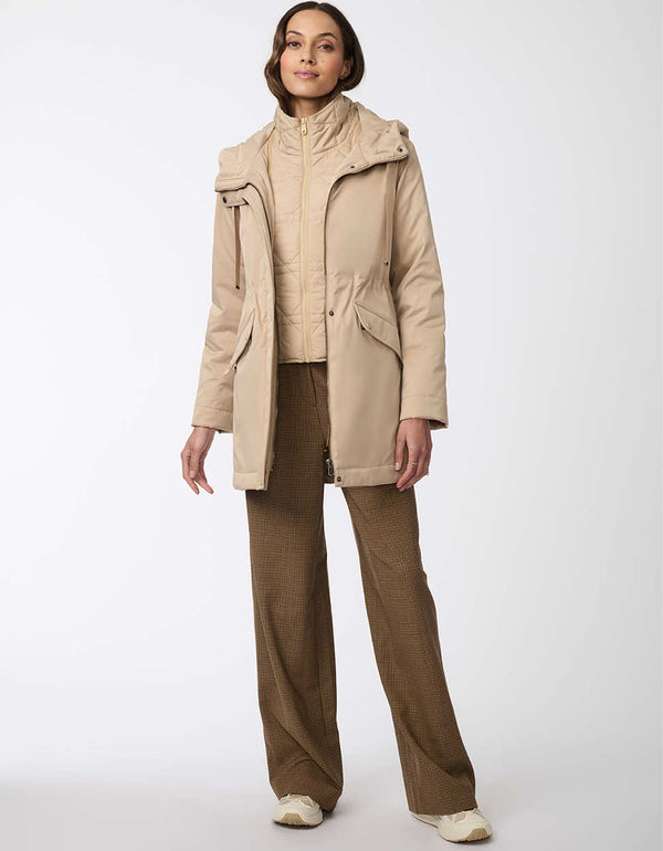 womens all weather thigh length zip up jacket with removable insulated bib and adjustable drawstring hood in beige