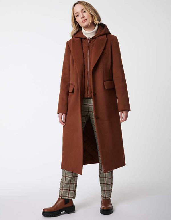 two pocket knee length wool coat for women in a burnt brown color with a removable bib for extra insulation