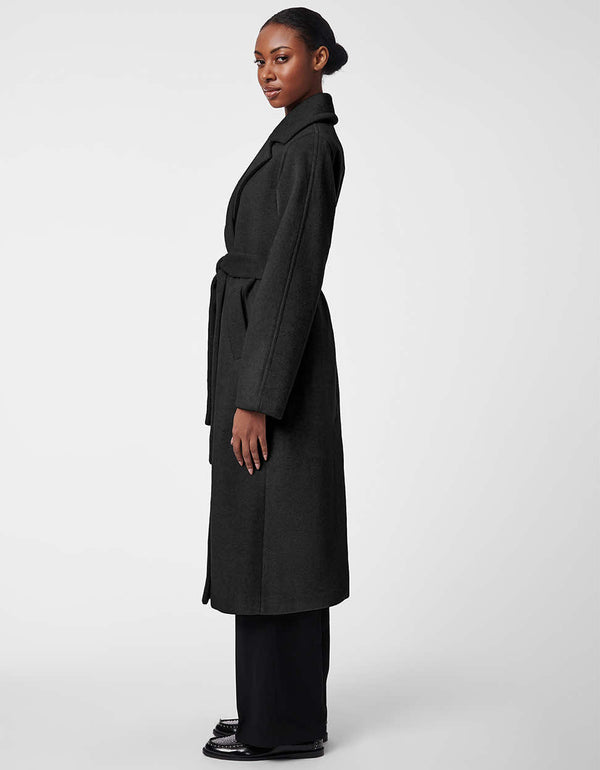 a classic yet stylish black belted wool coat for women geared with two deep side pockets and exaggerated sleeves