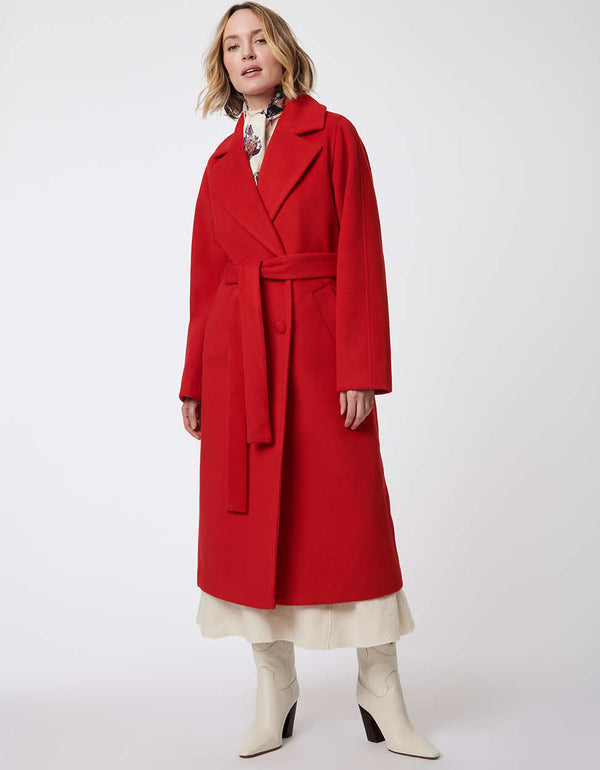 red trench coat with adjustable waist and two pockets along with buttons and classic below the knee cut for women