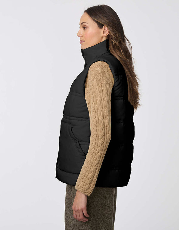 utilitarian puffer vest in black for women with large pockets and button up enclosure for layering