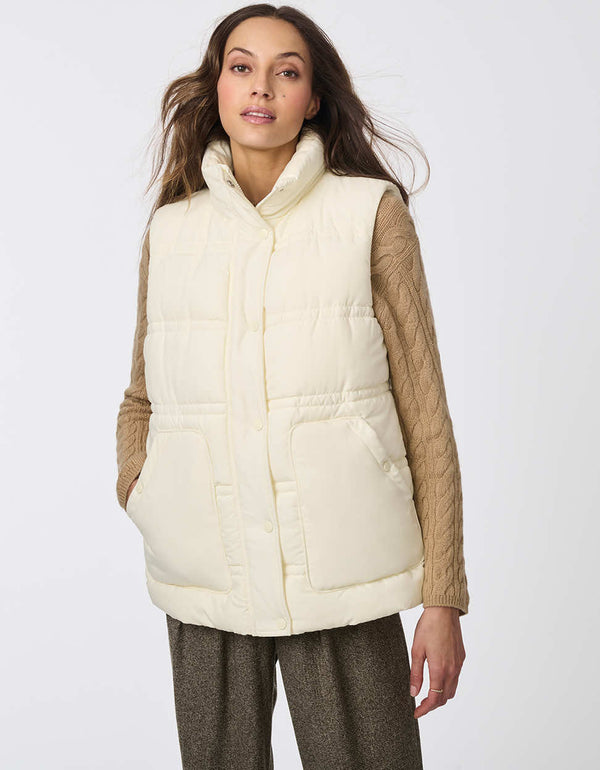 well insulated and sustainably made puffer vest for women in white with large pockets and fully button enclosure