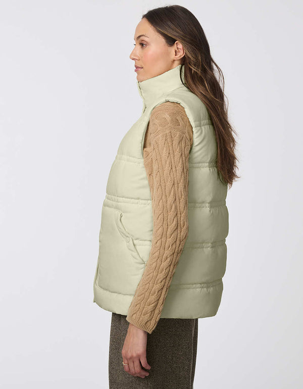 warm and cozy insulated puffer vest for women in light green with two large pockets for storage and high collar