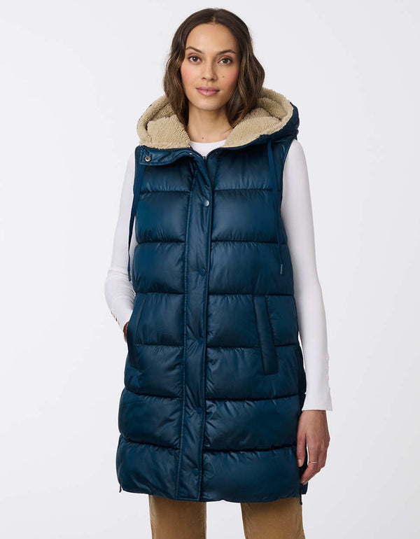 dark blue thigh length puffer vest with horizontal stitching for women made with sustainable insulation for warmth