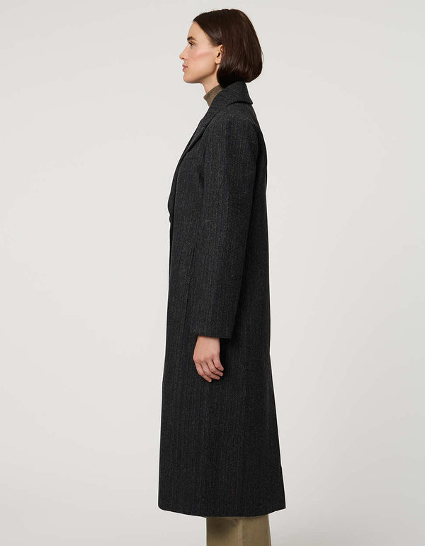 Women’s calf-length wool coat with double-breasted front and oversized lapels for modern tailored style.