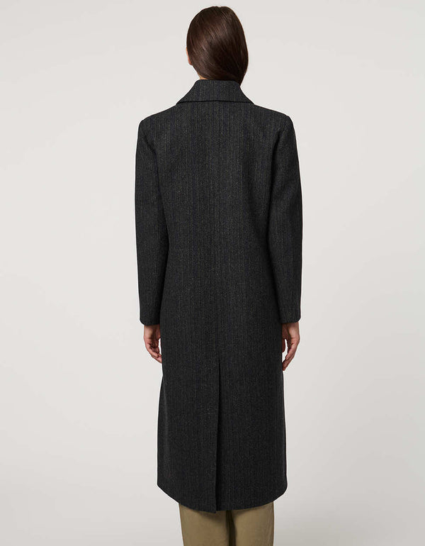 Women’s calf-length wool coat with double-breasted front and oversized lapels for modern tailored style.