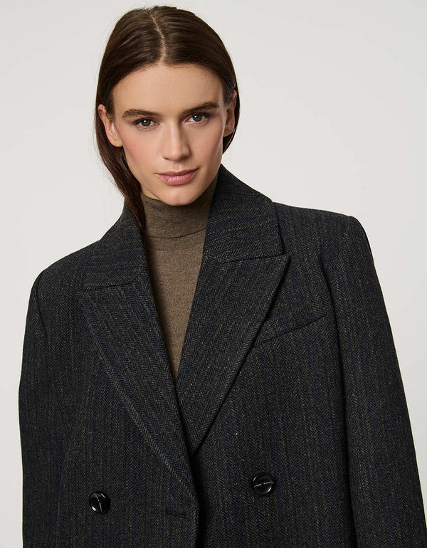 Women’s calf-length wool coat with double-breasted front and oversized lapels for modern tailored style.