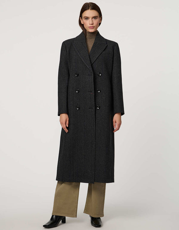 Women’s calf-length wool coat with double-breasted front and oversized lapels for modern tailored style.