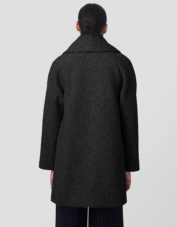 warm textured boucle coat in black oversized fit with double breasted closure perfect for layering in winter