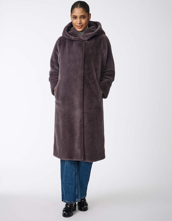 relaxed faux fur jacket with two pockets and hood for women to stay cozy and warm during colder months