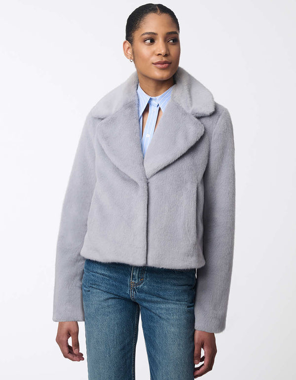 women's faux fur jacket with oversized labels and furrier clip closure. Hip-length for a modern style.