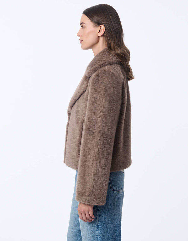 women's faux fur jacket with oversized labels and furrier clip closure. Hip-length for a modern style.