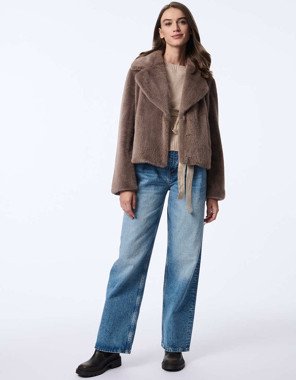 women's faux fur jacket with oversized labels and furrier clip closure. Hip-length for a modern style.