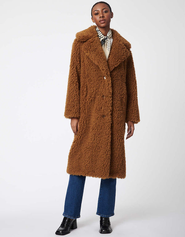 modern faux fur coat in camel brown for women with an oversized collar and two lined pockets