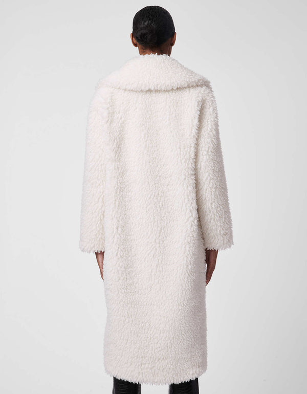 asymmetrically cut faux fur white coat with elongated back made and oversized neck made from animal friendly fabric