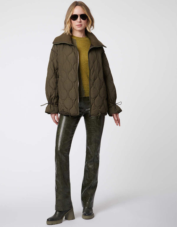 modern quilted jacket in olive green for women with multiple adjustable elements including the waist and cuff