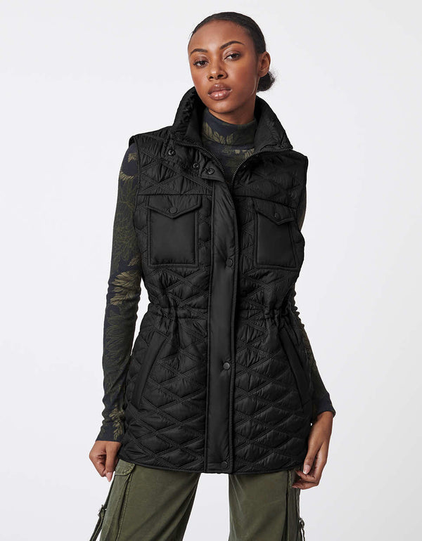 utility inspired puffer vest in black with full zip up enclosure and cinched waist for women