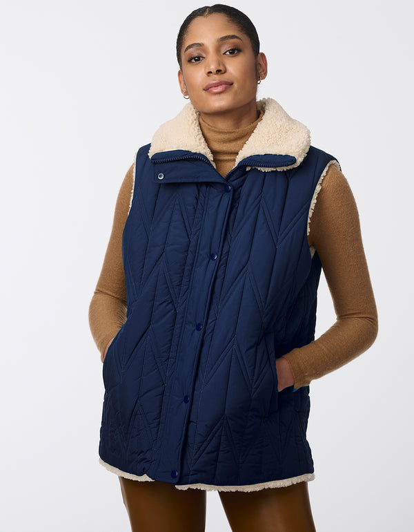 stylish and versatile reversible vest in navy for women with a quilted side and plush sherpa side for any occasion