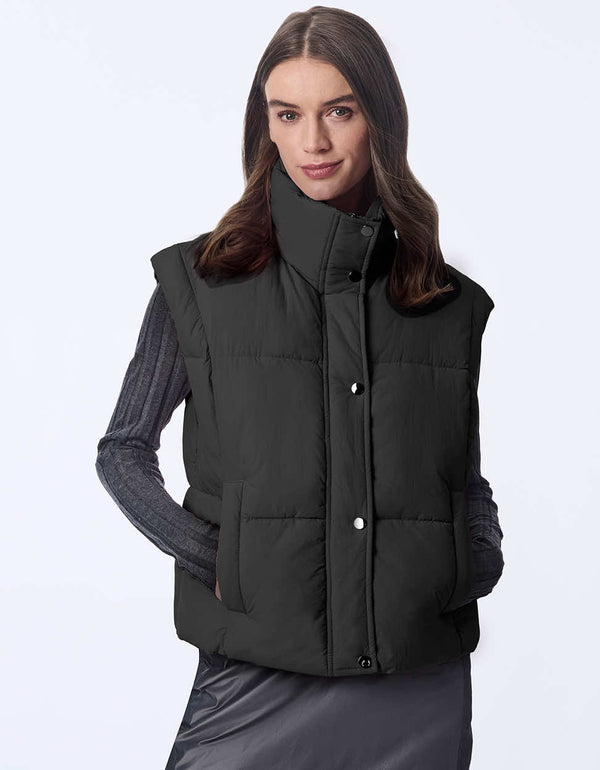 Women's sustainable puffer vest made with recycled materials. Hip-length with zipper and snap closure