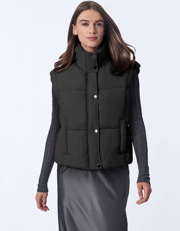 Women's sustainable puffer vest made with recycled materials. Hip-length with zipper and snap closure