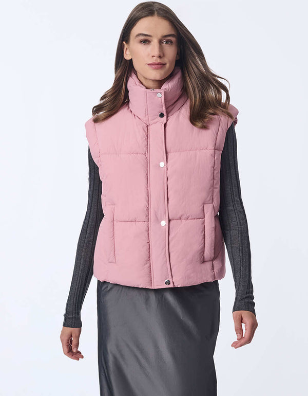 Women's sustainable puffer vest made with recycled materials. Hip-length with zipper and snap closure