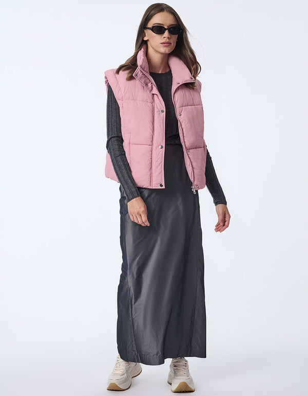 Women's sustainable puffer vest made with recycled materials. Hip-length with zipper and snap closure