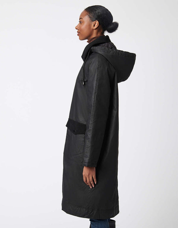 two pocket hooded rain coat in black made from pure cotton outer shell and recycled fabric lining for women