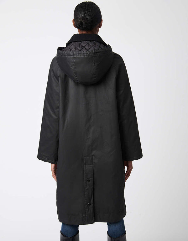 black modern rain coat for women with large hood and adjustable vent slit for flexible movement