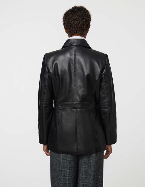 Long lamb leather shirt jacket with patch pockets and button front, blending utility with polish.